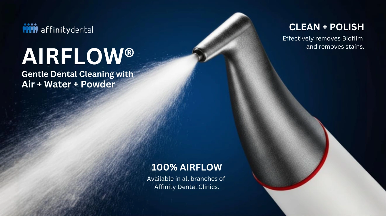 AIRFLOW® dental cleaning handpiece spraying air, water, and powder for gentle biofilm and stain removal at Affinity Dental Clinics