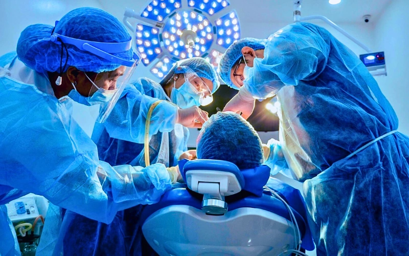 Affinity Dental Clinics oral surgeons performing advanced dental implant surgery in a modern surgical suite.