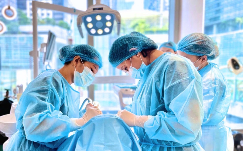 Dentists performing a dental implant procedure at Affinity Dental Clinics BGC High Street in Bonifacio Global City, Manila