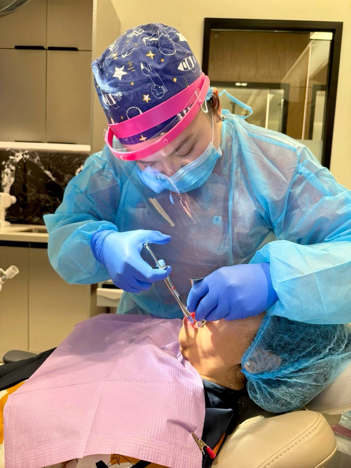 Dentist in full PPE performing a complicated tooth extraction at Affinity Dental Clinics Parañaque, Parqal Mall