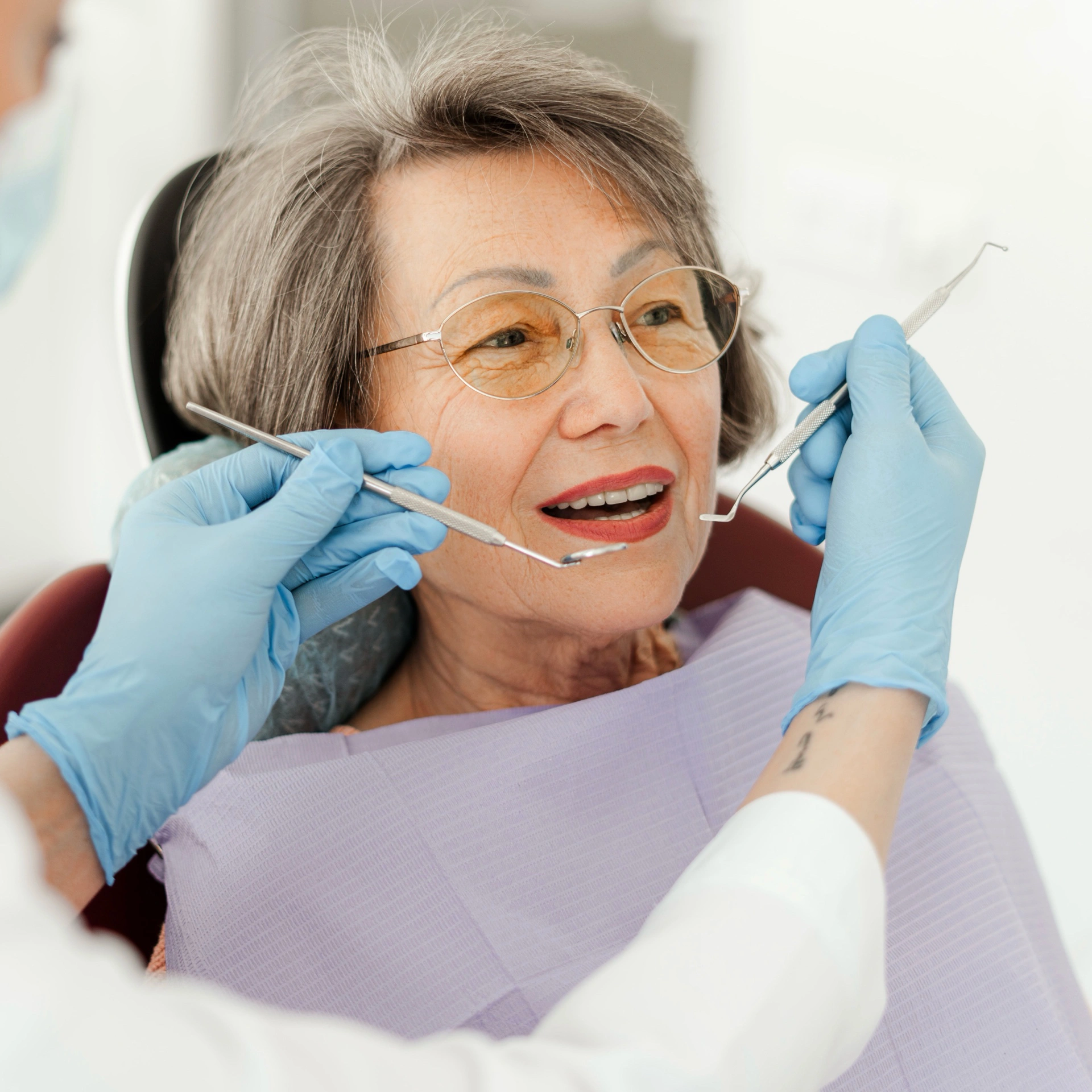 Senior woman receiving a dental check-up, highlighting geriatric dental care at Affinity Dental Clinics.