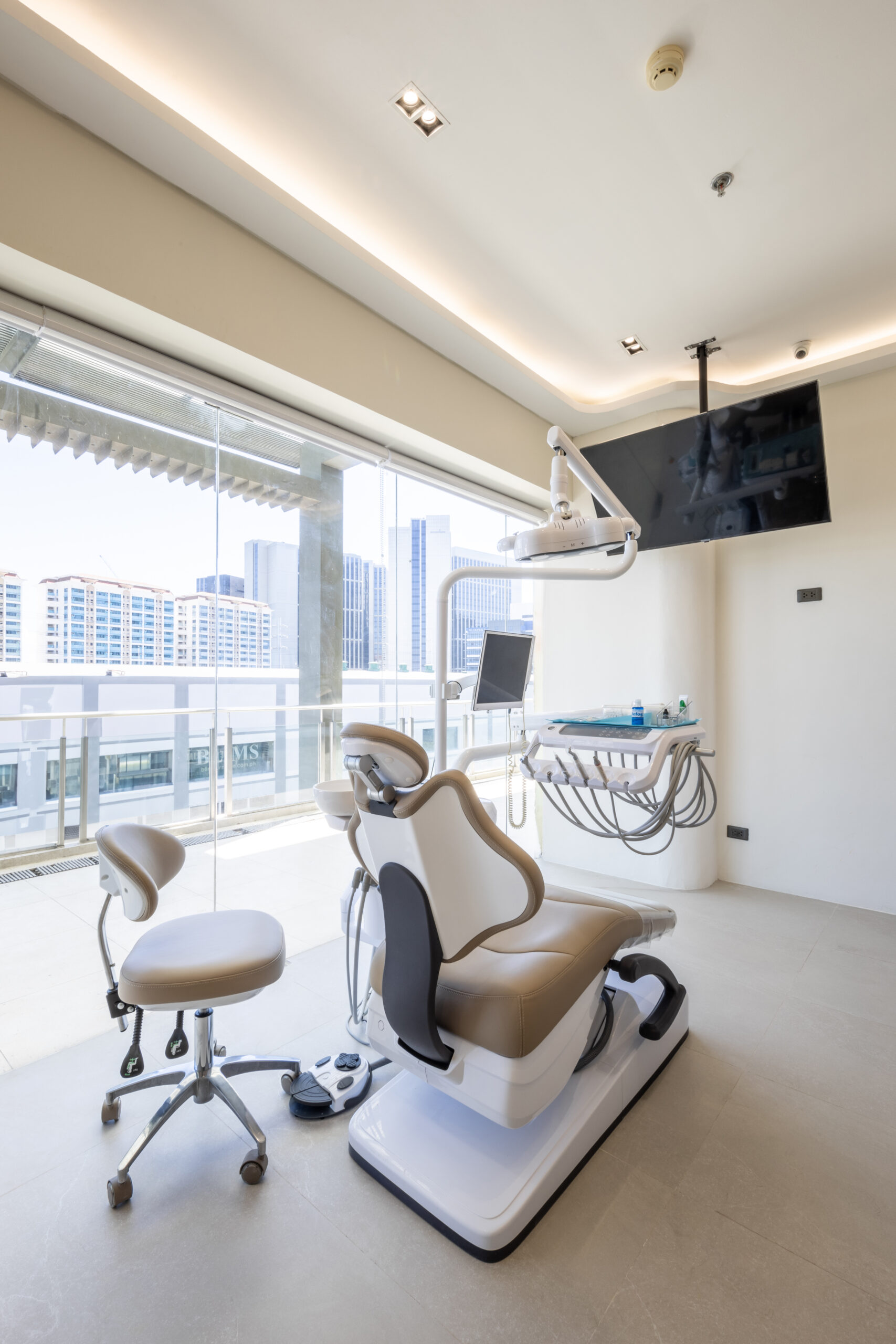 Dental treatment room with panoramic city view and modern equipment at Affinity Dental Clinics Alabang