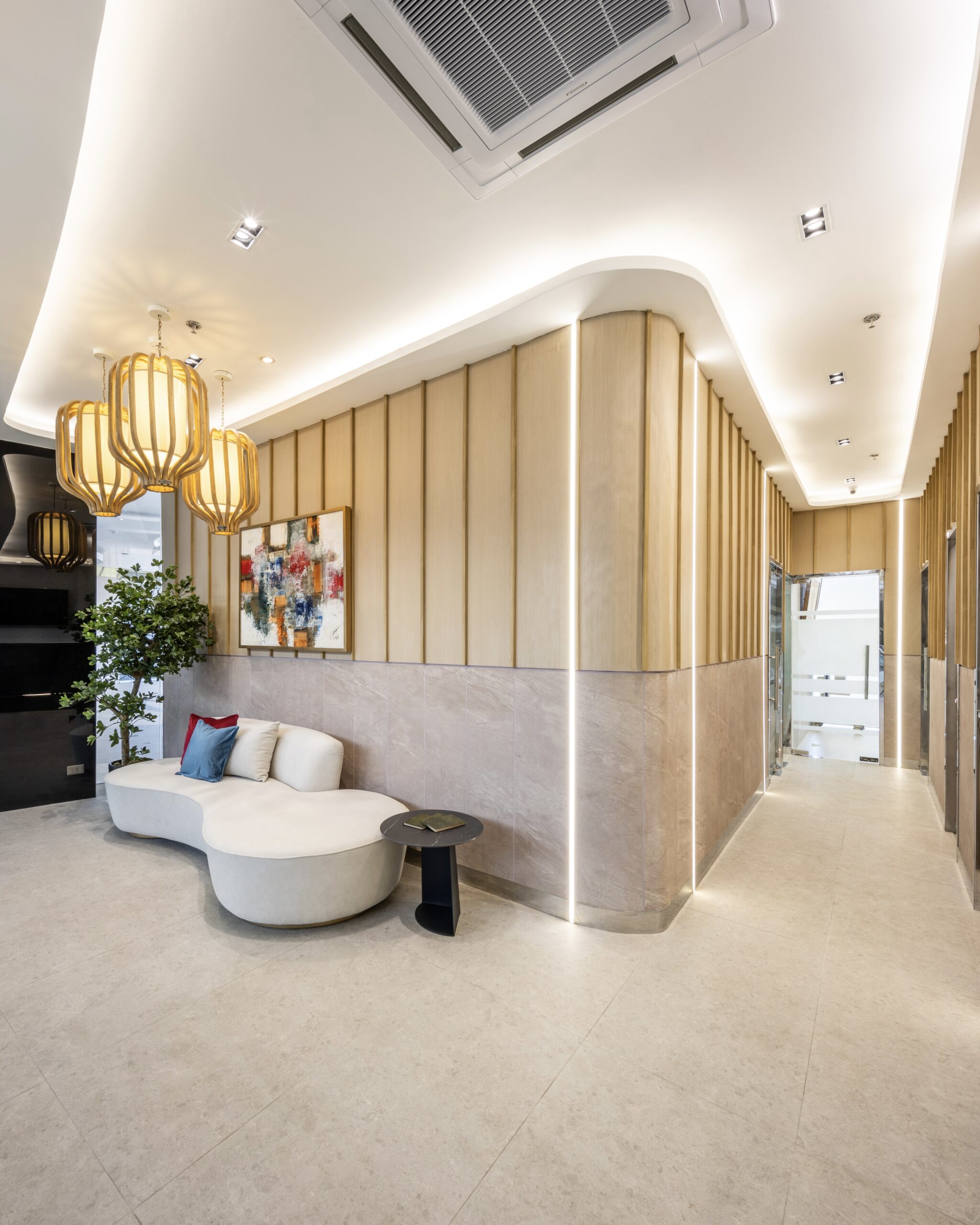 Modern and elegant reception area of Affinity Dental Clinics Alabang featuring cozy seating and warm lighting