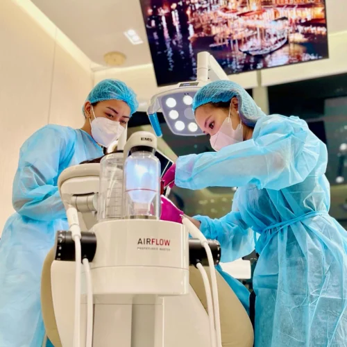 Dentists performing AIRFLOW® cleaning procedure with EMS device at Affinity Dental Clinics BGC High Street