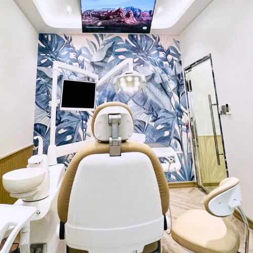 Dental chair with ceiling TV and tropical-inspired wallpaper at Affinity Dental Clinics BGC Stopover