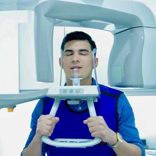 Male patient undergoing a digital panoramic dental X-ray at Affinity Dental Clinics Makati.