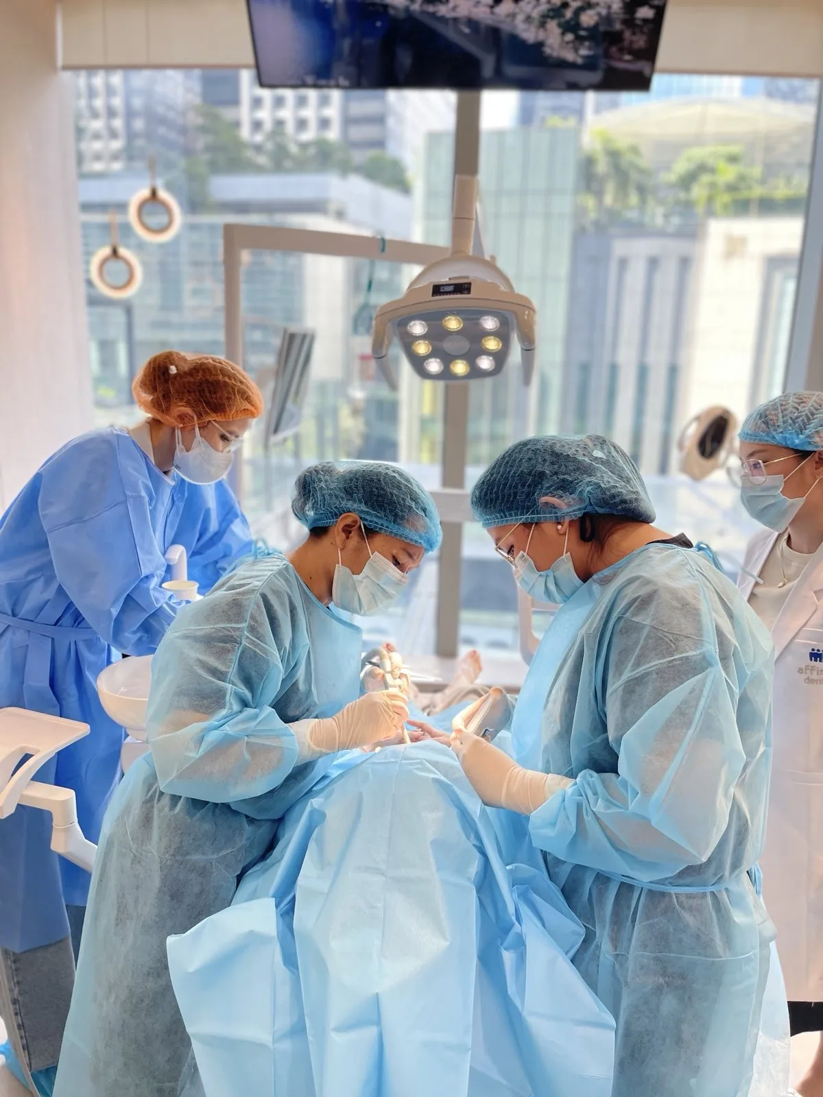Dr. Del Mundo performing dental implant surgery under sedation at Affinity Dental Clinics BGC High Street