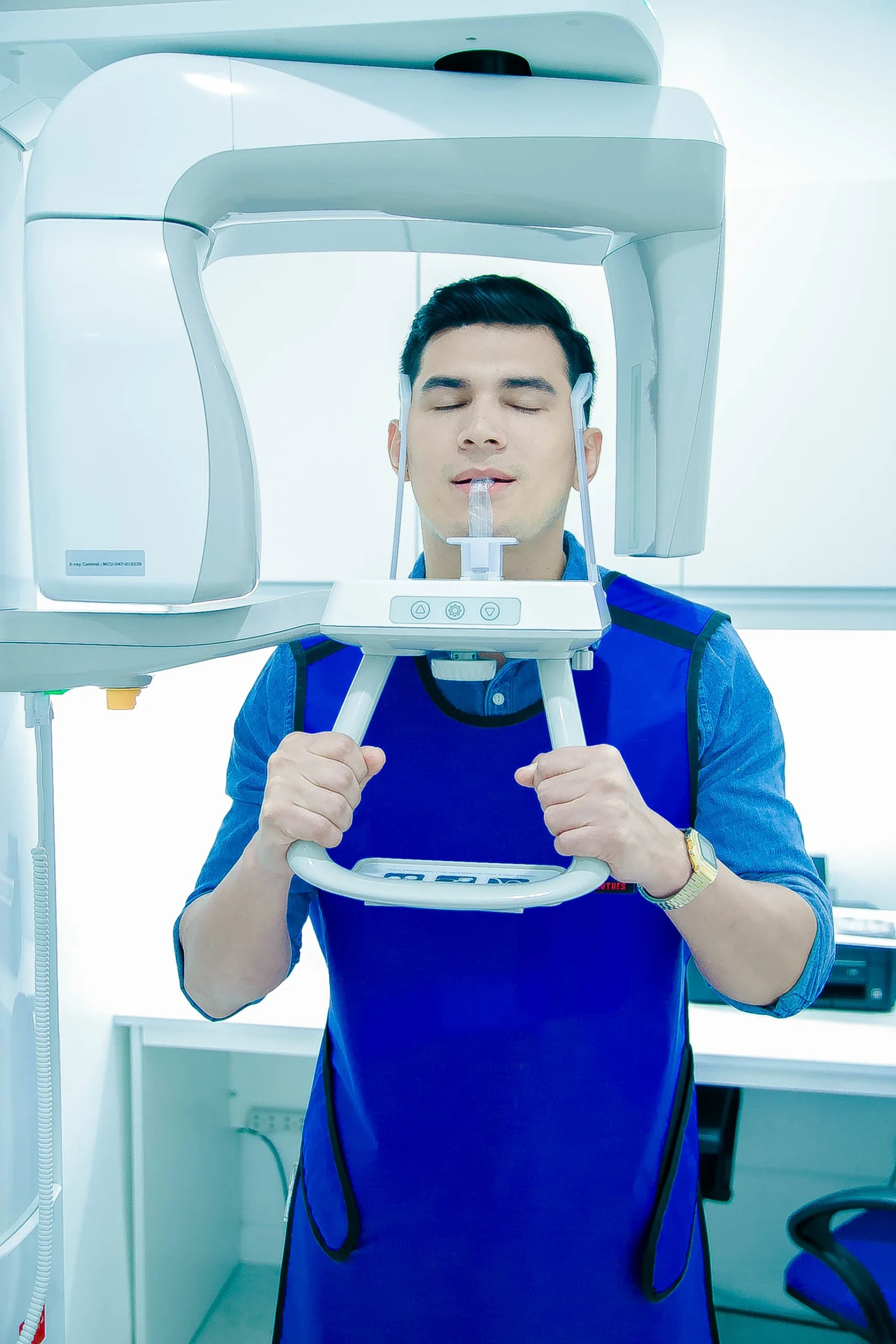 Smiling dentist or orthodontist holding clear dental aligners in modern clinic